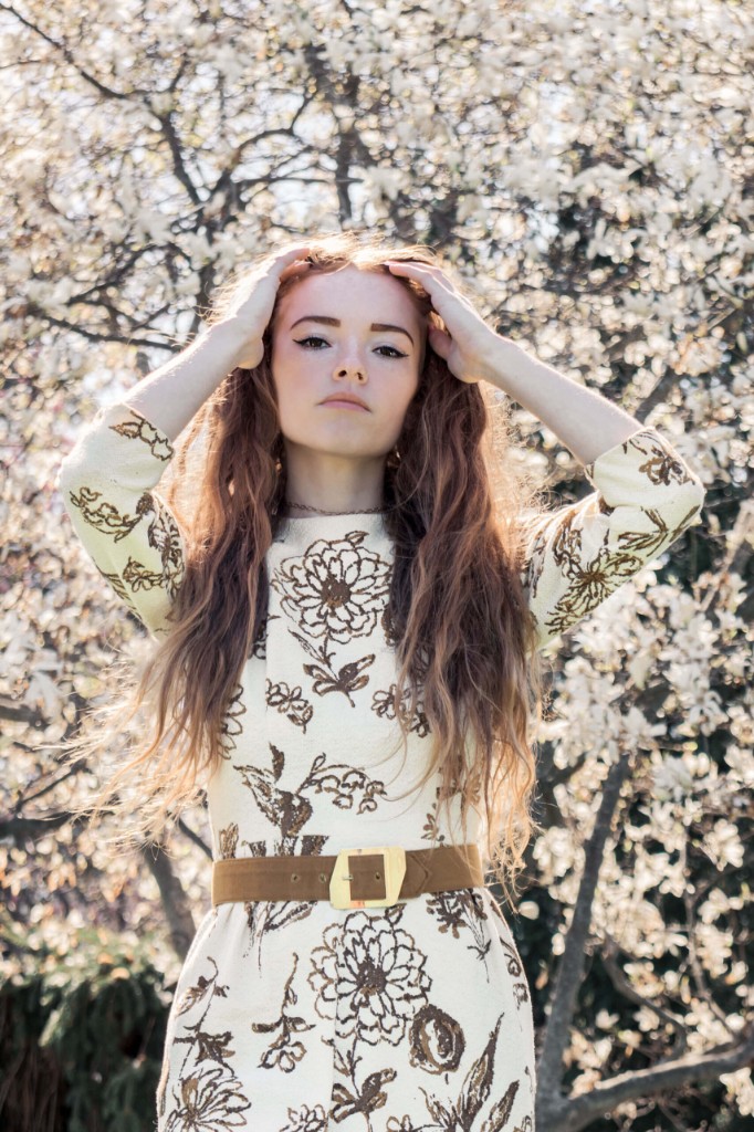 Cassie with hands in her hair in front of a flowering tree — Abigail Dumlao Photography & Film