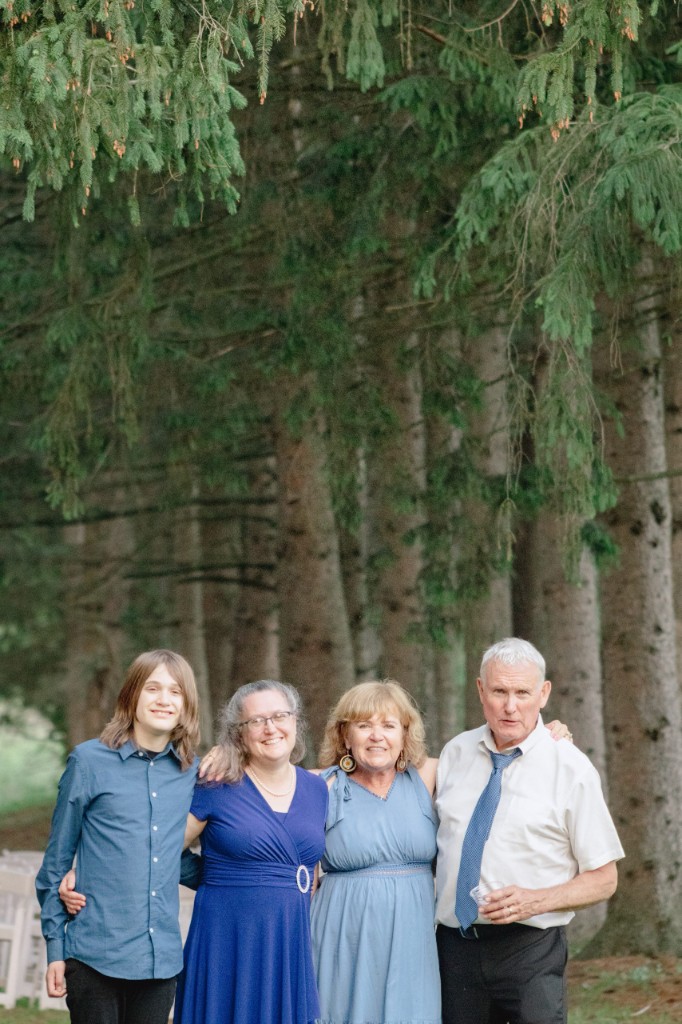 Family of four standing together in a pine forest — Abigail Dumlao Photography & Film